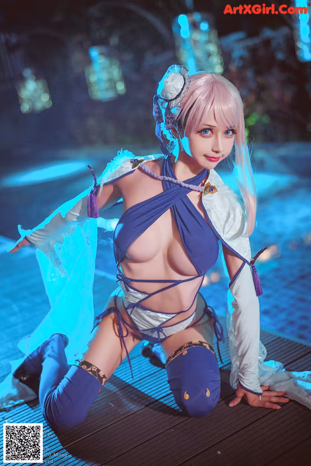 A woman in a blue and white outfit posing for a picture.