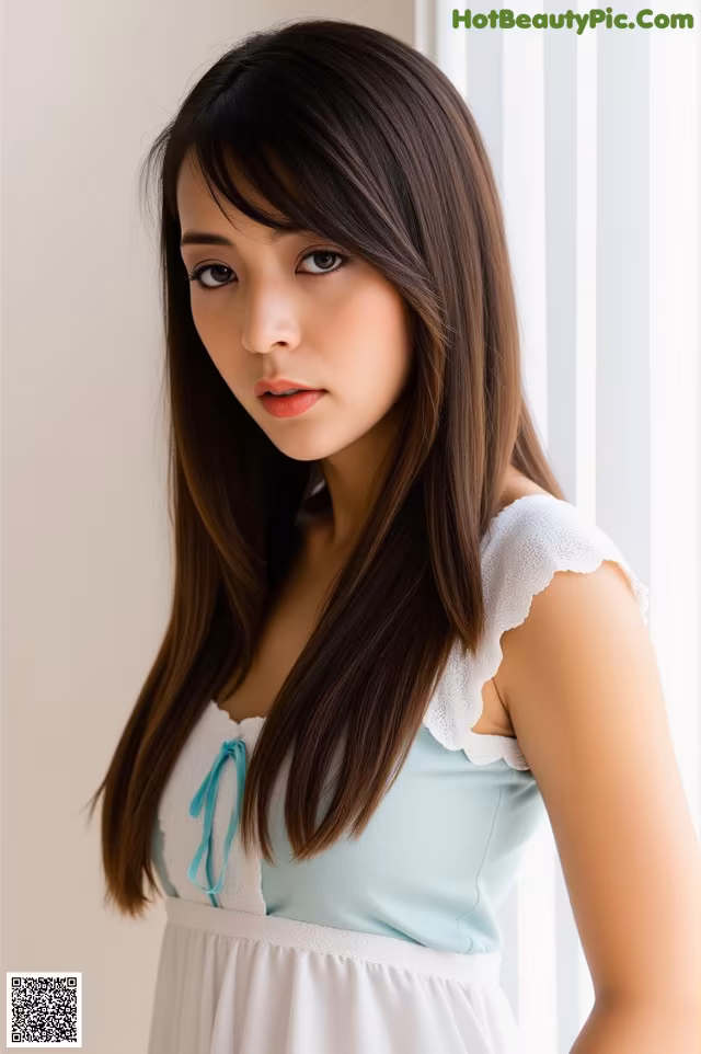 A woman in a white dress posing for a picture.