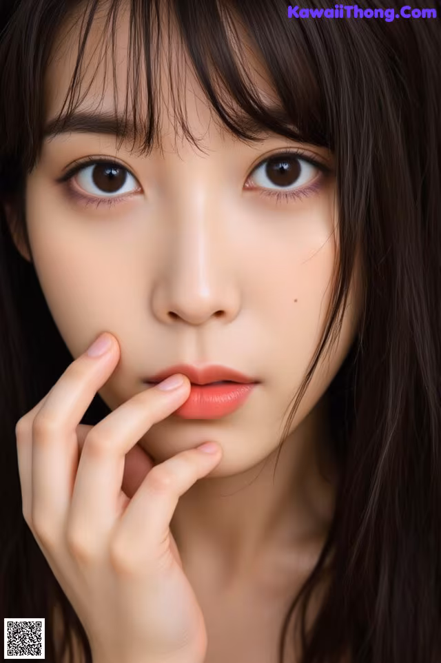 A woman with long black hair and a pink lipstick.