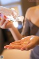 A woman pouring water into her hands. 