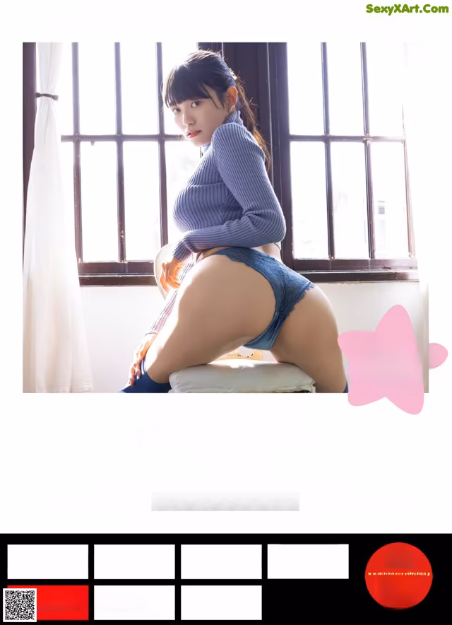 A woman in a blue sweater is sitting on a window sill.