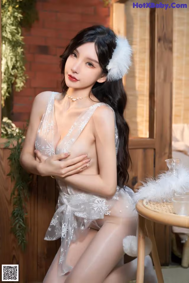 a woman in a white lingerie sitting on a chair